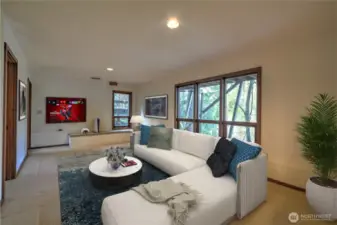 Downstairs Rec Room leading to the 2 Guest Bedrooms, Full Bathroom and Laundry Room. - Virtually Staged