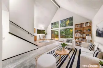 Living room with vaulted ceilings and view of trees