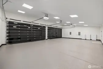 Oversized 4 car garage with heated and epoxied flooring.