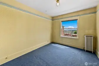 Your east facing bedroom also have water views.  You can see the hardwood floors under the radiator.
