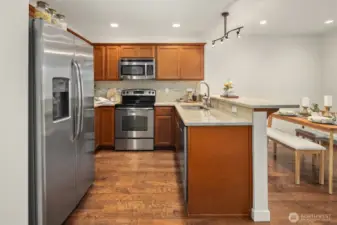 Open kitchen with eat at bar and space for dining table