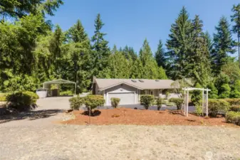 Set on a shy acre of serene Northwest beauty, there’s plenty of space to garden, relax, or entertain outdoors. Notice the covered RV parking plus two storage sheds!