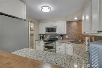 The breakfast bar was custom-made for this kitchen. It is what you see at the bottom of the screen. This adds to the open feel of the home!