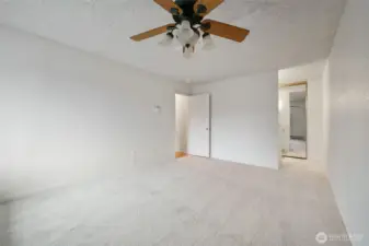 Primary suite with an overhead fan for added comfort and a private bath.