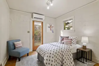 Second main floor bedroom, with a door leading to the back deck.