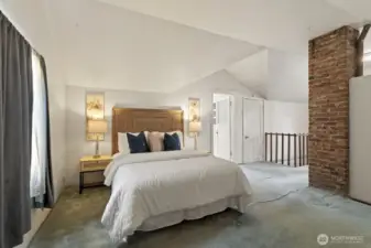 Tall ceilings and large windows fill the upstairs primary suite with natural light.