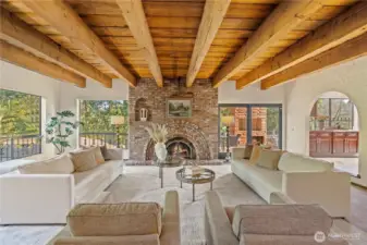 Livingroom is stunning with its brick fireplace and exposed beam ceilings.