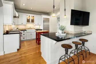 Kitchen with eating bar flowing into sitting area.