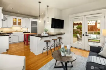 Flow between kitchen and sitting room with french doors opening to back deck.