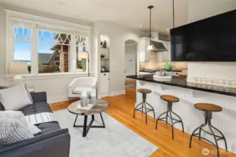 Sitting area with eating bar & large windows offering sound views.