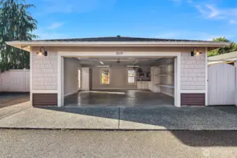 Detached two car garage with additional parking. The garage has built-in vacuum system, 220, built in air compressor, fridge, and storage!