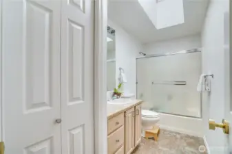 Full bathroom in the hall has additional linen closets.