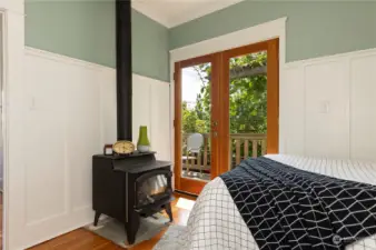 Second bedroom opens to the porch and features a wood stove.