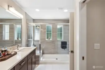 Bright and spacious Primary En-Suite w/ beautiful tile and quartz countertops.