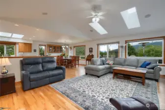 Large open family room with vaulted ceiling and sky lights