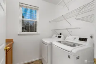 Laundry Room: Convenient laundry space with washer, dryer, and shelving