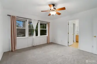 Living Room: Cozy space featuring a fireplace, ceiling fan, and open access to the kitchen.