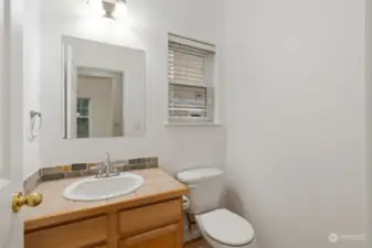 Bathroom: Clean bathroom with a modern layout, dual sinks, and a large window.