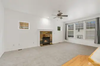 Living Room Fireplace - Cozy space with natural light and a warm fireplace.