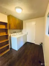 Large laundry room off kitchen with access to garage and guest bathroom.