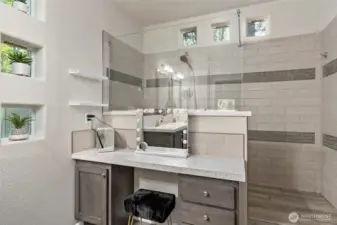 Vanity and tiled shower.