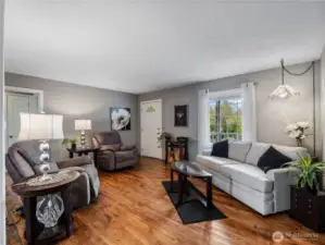 The living room features custom hand-hewn hickory hardwood floors.