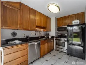 The kitchen stays bright with the large sliding glass door covering the back wall.