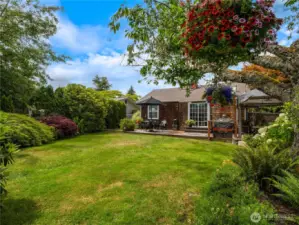 The trees and flowers in the backyard create a private oasis.