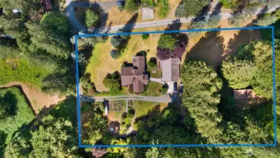 Birdseye view of lower 2.4 acreage, includes main home, shop, covered RV parking & bathhouse