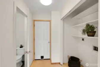 Laundry to the right, Garage straight ahead and half bath on left.