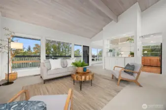 Looking across the living room toward the park and the bay views, with the kitchen and dining room beyond.
