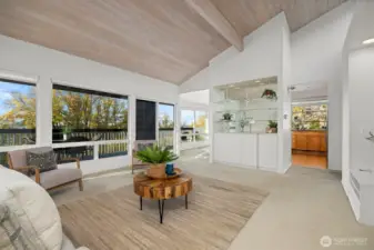 Looking across the living room toward the park and the bay views, with the kitchen and dining room beyond.
