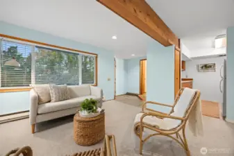 There is a large living area that has beautiful beams in the apartment.