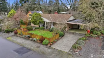 This unique lot has two driveways (one not showing in photograph).  The driveway showing leads to a 2-car Carport with room for additional parking in driveway.  The other driveway holds room for another vehicle, camper, boat, etc., and is located to the left.  Additionally the gravel in front of fence holds 2 vehicles and is great for visitors.