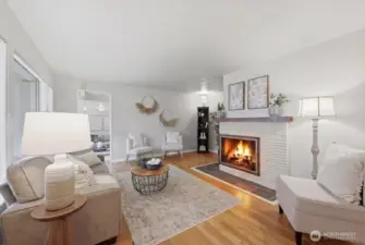 Cozy up to your wood burning fireplace, and or use the electric insert in place! Unplug and remove with ease for use of wood if desired. Switch back and forth for different seasons/desires.  Wood grate in outside shed!  The ambiance against the original Hardwood floors, large picture window and cozy nooks make this a space so welcoming and charming.  Freshly painted walls, ceiling & fireplace!