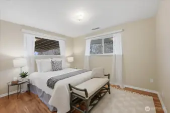 This is the largest of the 3 bedrooms and with the full bathroom just steps away, this room would ge great for a primary bedroom, as it is the largest of the 3.  Though, any would work!  This room offers two windows allowing for great sunlight, and offers and oversized window sill which is to die for,  Freshly painted walls, doors and trim and of course look at these beautiful, original Hardwoods!