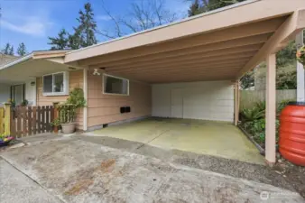 Attached 2-car Carport with large shed through door at back and a door from backyard as well.