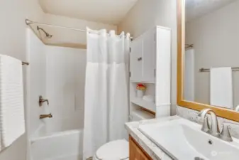 The full guest bathroom w/shower-tub combo features modern fixtures and ample space, ensuring comfort and convenience.