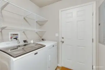 A practical utility room comes equipped with a washer and dryer, making laundry day a breeze.