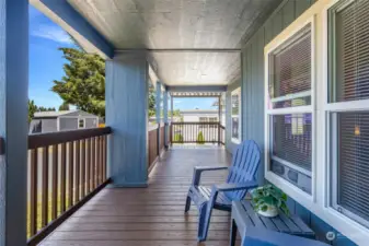 Freshly painted balusters and a durable Trex deck, all illuminated by elegant recessed lighting for a perfect outdoor experience.            Unwind on the spacious covered front porch, featuring freshly painted balusters and a durable Trex deck, all illuminated by elegant recessed lighting for a perfect outdoor experience.