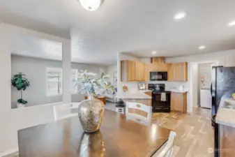 Imagine preparing meals in this modern eat-in kitchen, complete with elegant wood cabinetry, a convenient breakfast bar, and new appliances.