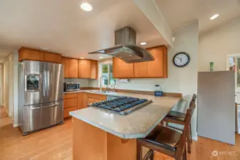 Updated kitchen includes SS appliances, 6 burner gas stove, insta-hot, eating bar and bamboo flooring!