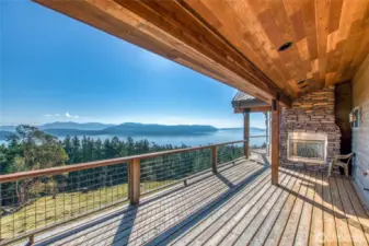 Wrap-around deck offers plenty of space to enjoy the view. Propane fireplace makes for cozy evening celebrations. This area of the deck is adjacent to one of two main bedrooms on main level.