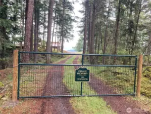 Gated driveway protects privacy at the end Pine Ridge Road.