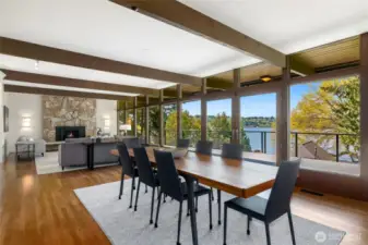 Step into sun-drenched interiors where walls of window blur the boundaries between inside and out. The expansive living and dining areas open effortlessly through French doors extending your living space onto an Expansive deck, inviting you to relax, entertain, while enjoying lake views, and calming the natural surroundings including humming stopping by for a visit.