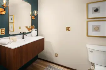 Updated bathroom with new vanity, toilet and light fixtures.
