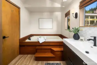 The bathroom includes jetted soaking tub, shower, separate toilet and skylight.