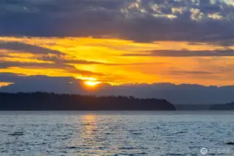Mesmerizing sunsets over the islands and Olympics.