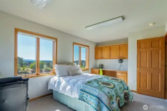 This versatile space offers a built-in desk and upper cabinets—ideal for working from home, crafting, or study. Large windows invite in natural light and scenic views to keep you inspired.