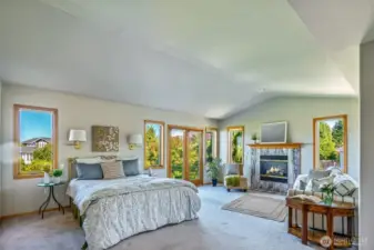 The grand Primary Suite offers space to truly unwind—complete with a marble-surround fireplace, sitting nook, abundant natural light, and French doors to your own outdoor escape.